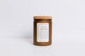 Frosted brown recycled glass Candle jar with cork lid and 'Stay Awhile' label on a white background