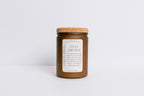 Frosted brown recycled glass Candle jar with cork lid and 'Stay Awhile' label on a white background