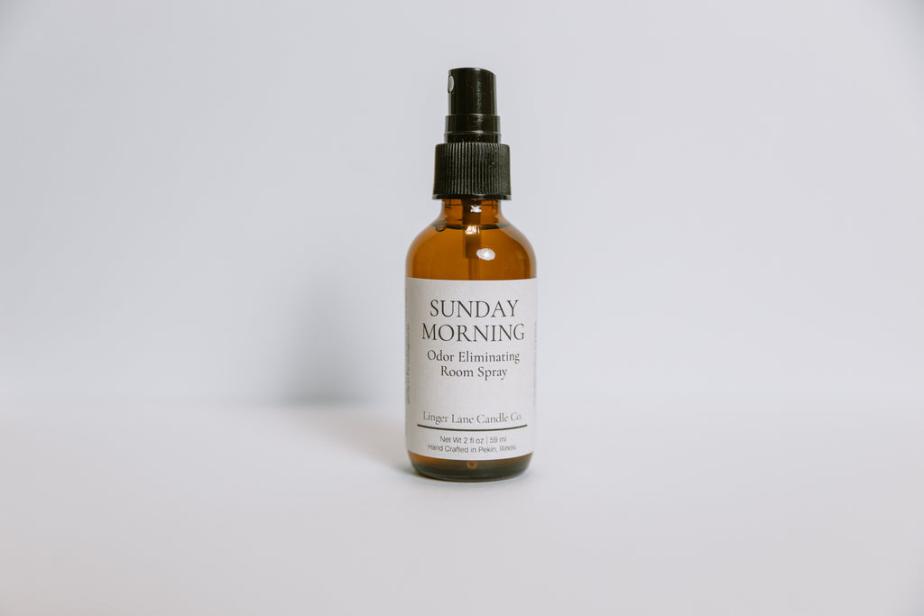 Bottle of Sunday Morning odor eliminating room spray on a white background