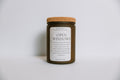Scented soy candle in a jar labeled 'Open Windows' with a cork lid on a light gray background
