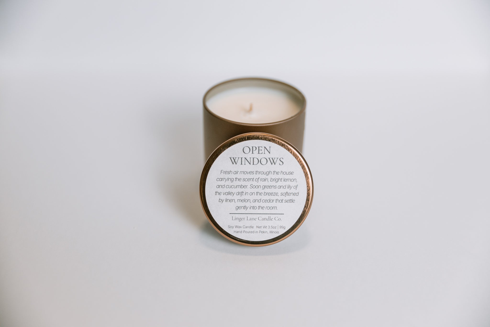 soy Candle in a bronze tin with a label on a white background