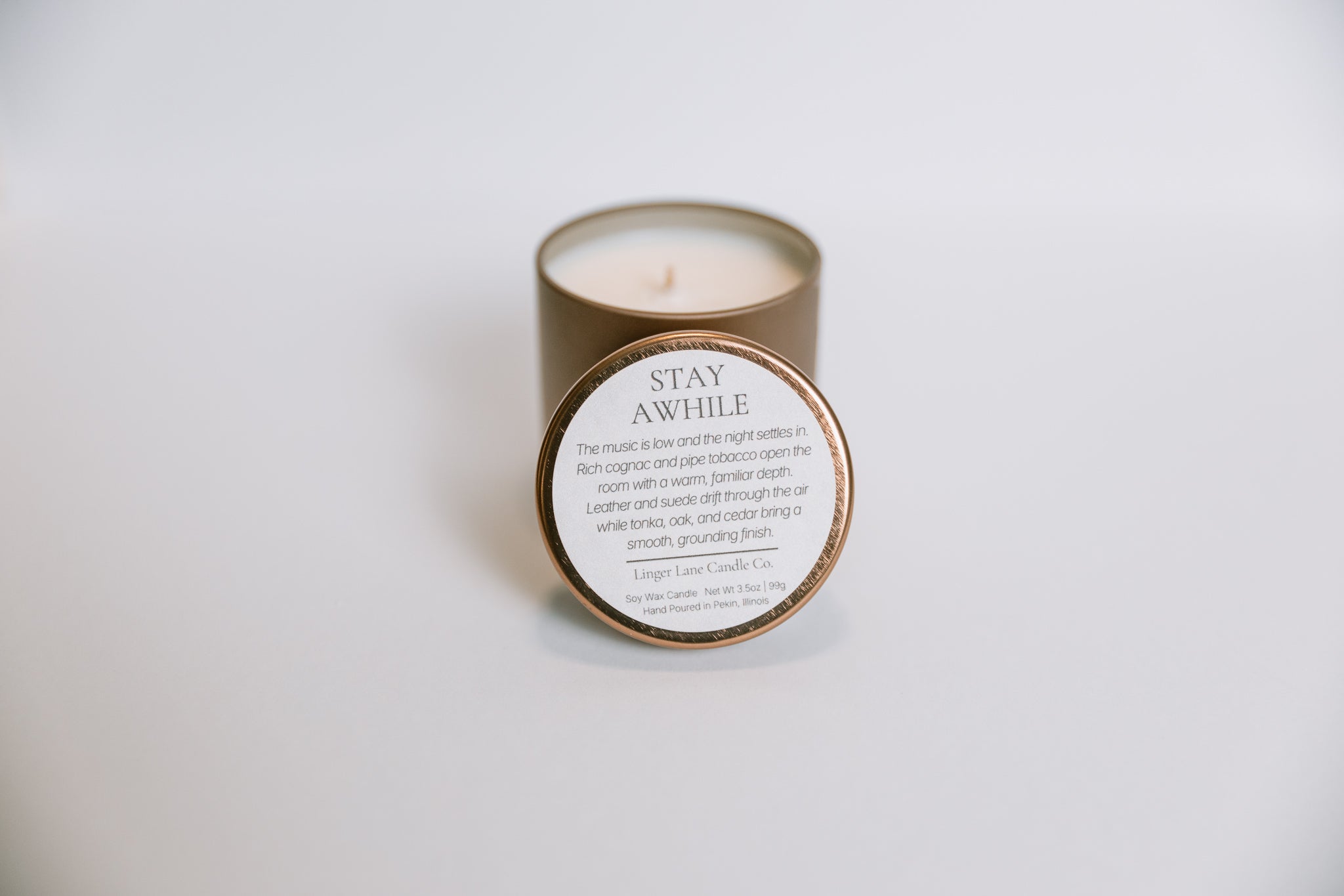 scented Candle in a bronze container with a label on a white background