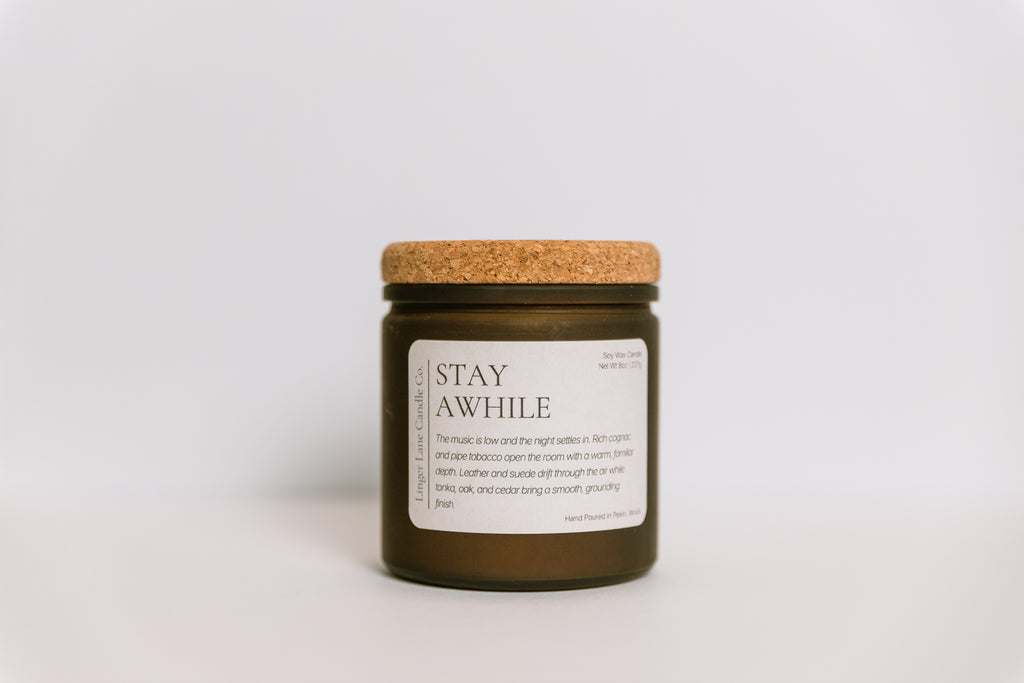 Hand poured, soy Candle with a cork lid and label on a light gray background