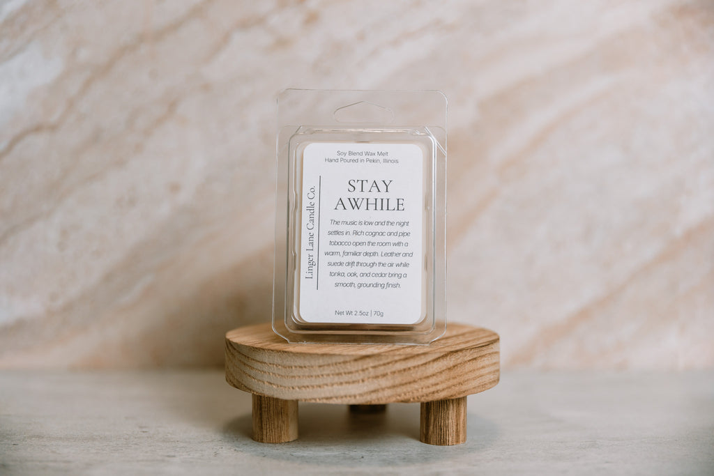 Candle melt wax bar on a wooden stand with a neutral background