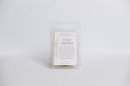 Wax melt container with 'Stay Awhile' text on a white background